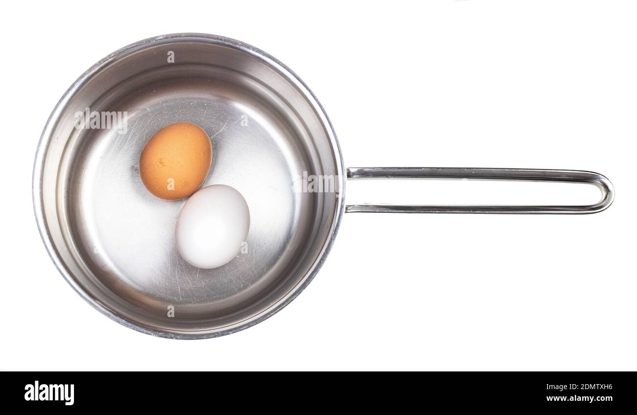 top view of two eggs in saucepan with water isolated on white background Stock Photo