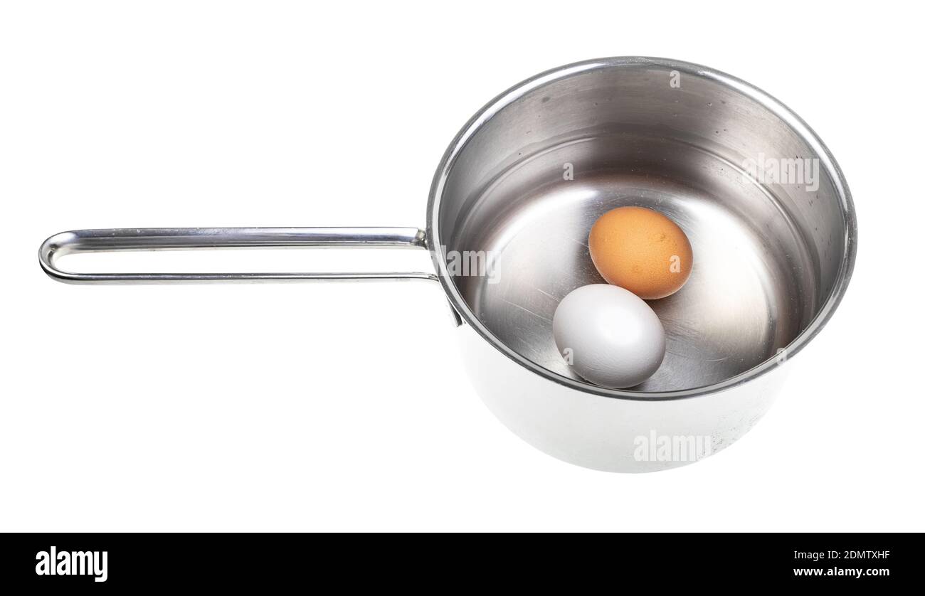 two eggs in saucepan with water isolated on white background Stock Photo