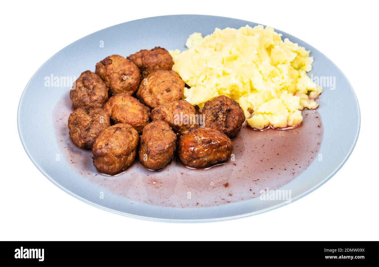 cooked swedish meatballs with lingonberry sauce and mashed potatoes on blue plate isolated on white background Stock Photo