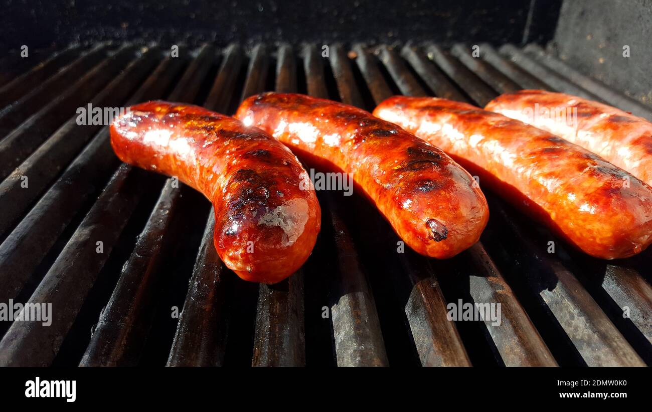 Sausage Cooking On A Grill Stock Photo