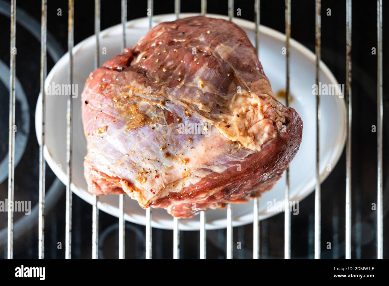 cooking Roast beef at home - marinated piece of beef on grill grate at home  kitchen Stock Photo - Alamy