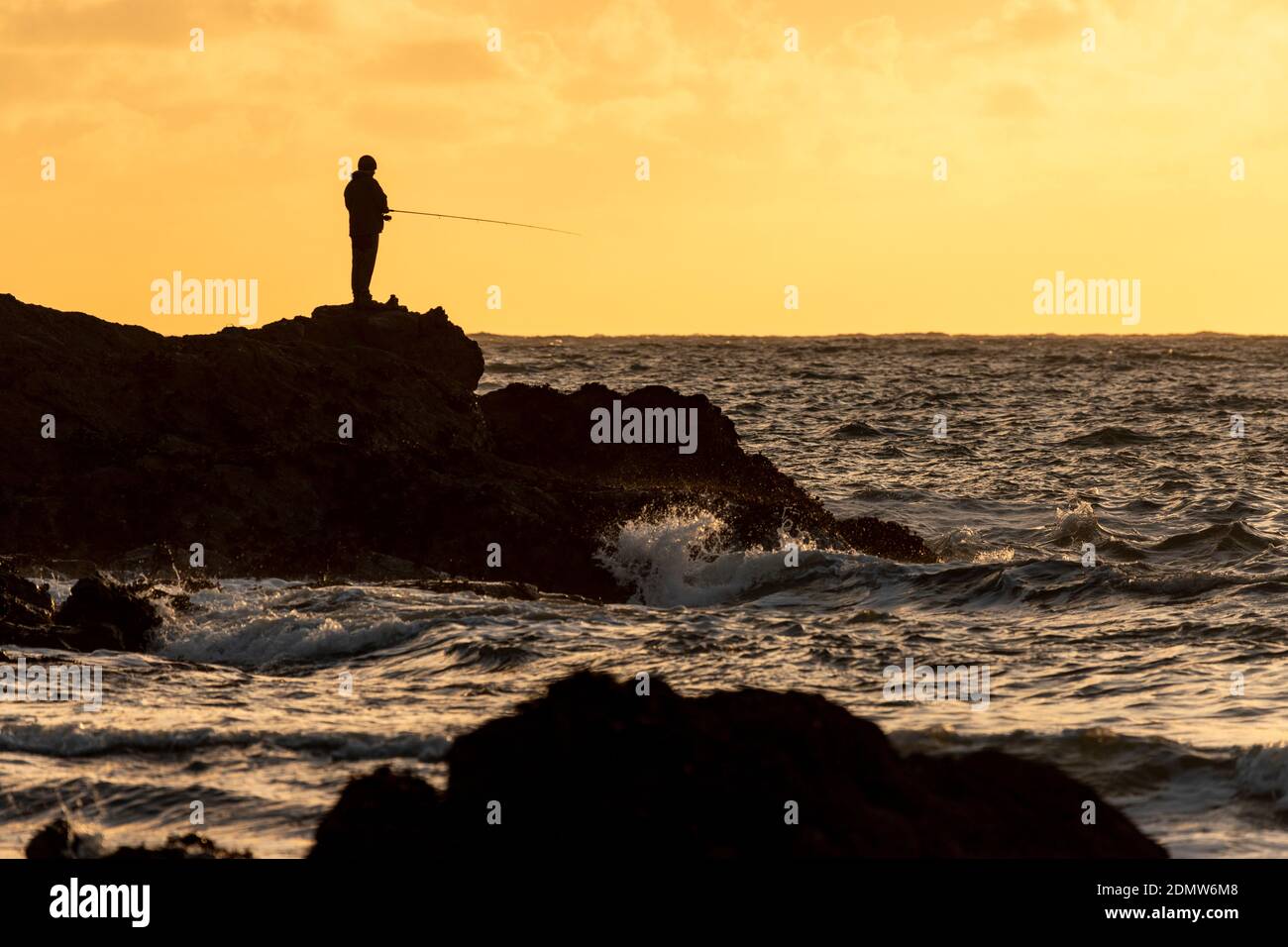 Sea angler at Porth Dafarch, Anglesey, North Wales Stock Photo