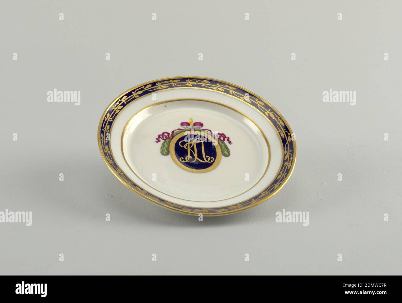 Plate, Imperial Porcelain Manufactory, St. Petersburg, Russia, Glazed porcelain, Dessert plate with gold monogram of Konstantin Pavlovich in blue oval, framed with gold and crested by purple crown and green wreath. Gold laurel on blue band around edge., St. Petersburg, Russia, ca. 1780, ceramics, Decorative Arts, Plate Stock Photo