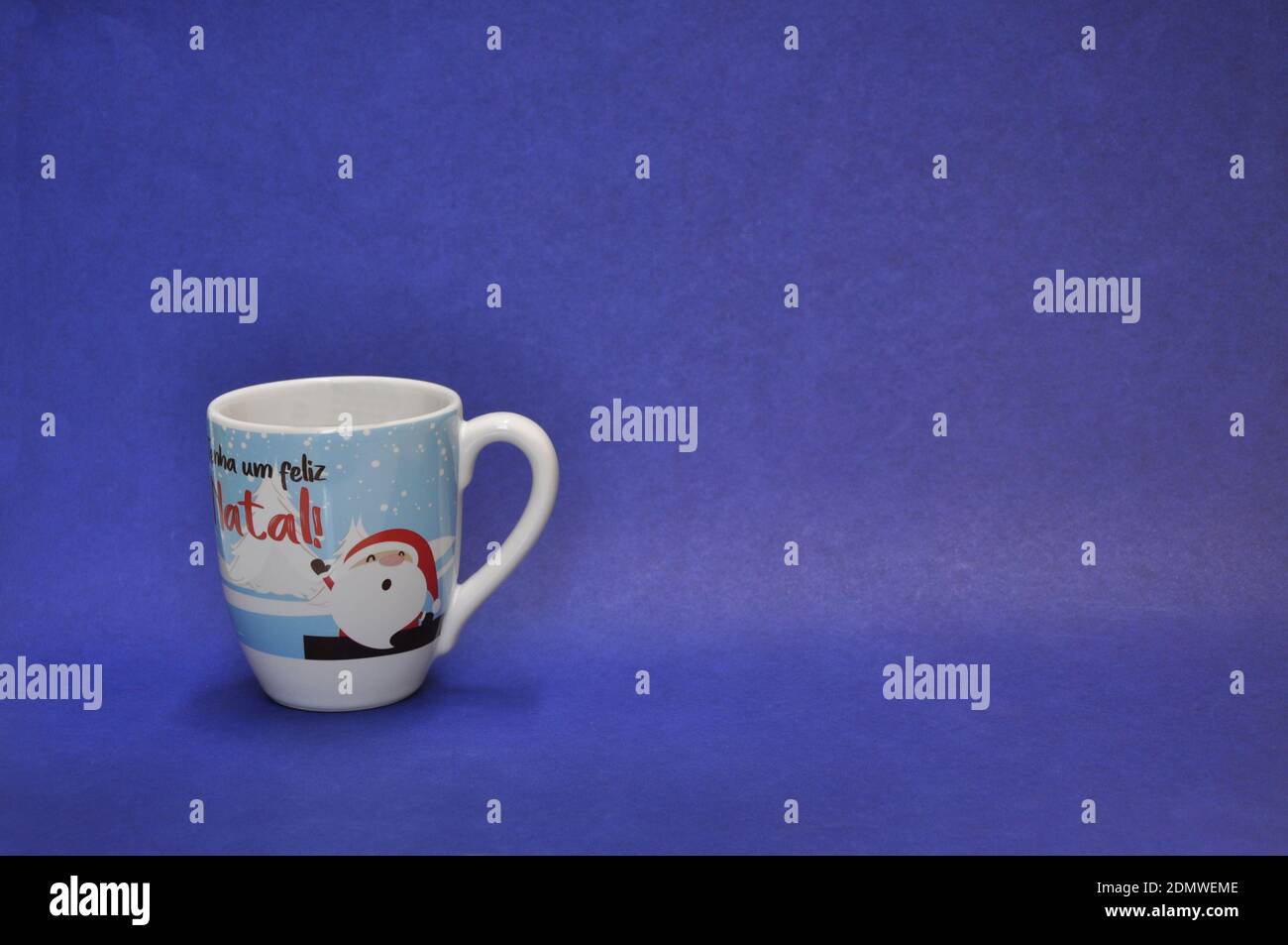 Beer mug with santa claus with the text have a merry christmas, on blue background and negative space Stock Photo