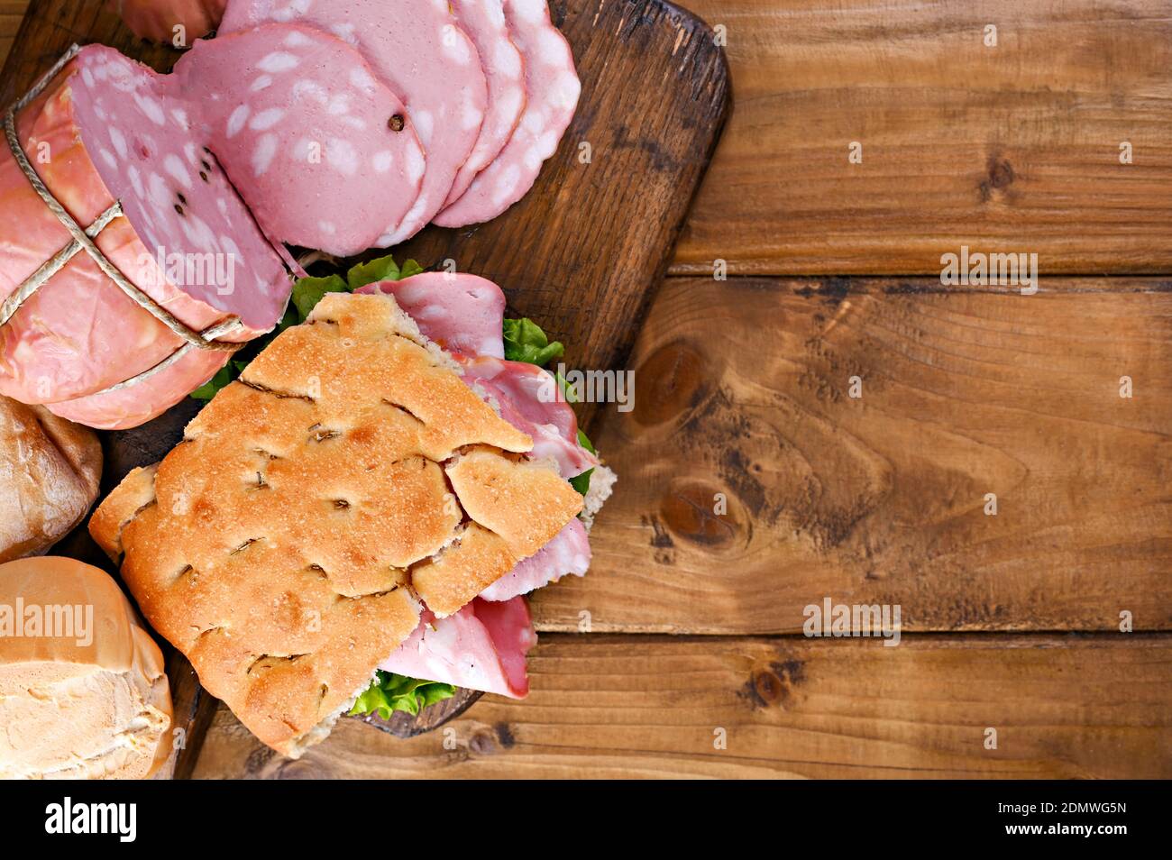 Italian Mortadella sliced. Focaccia with rosemary for lunch with