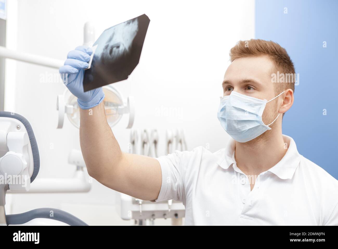 Modern technologies. Professional dentist examining dental xray of jaw