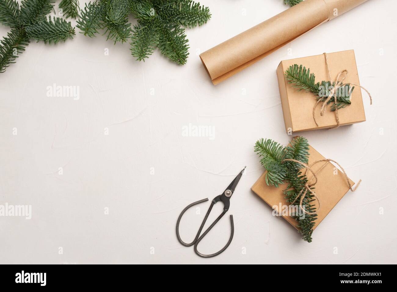 Christmas composition with green fir branches and kraft paper gift ...