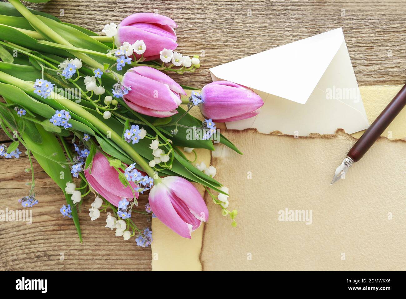 Bouquet of pink tulips, lily of the valley and forget me not flowers. Spring decor Stock Photo