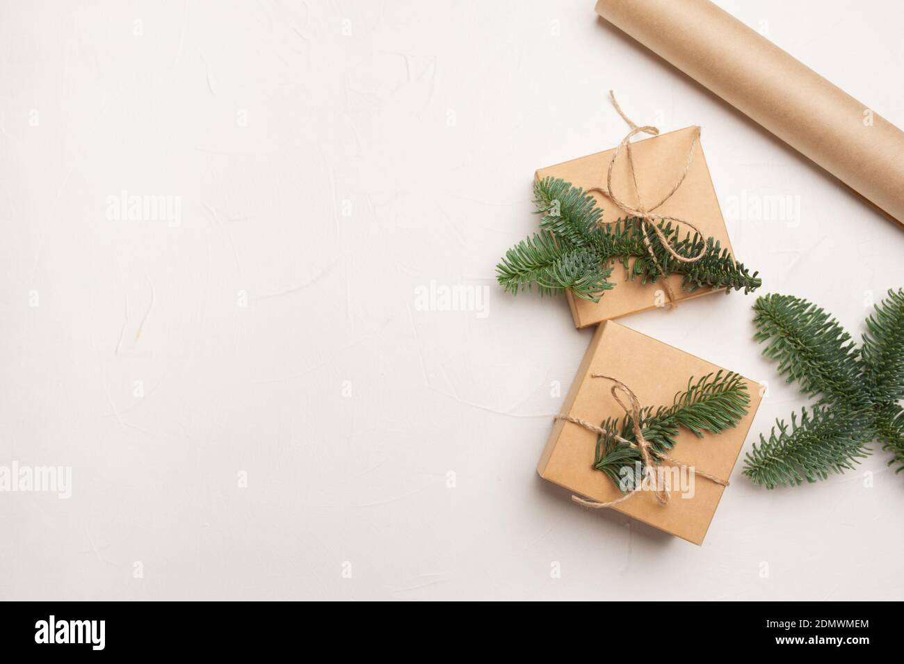 Christmas composition with green fir branches and kraft paper gift ...