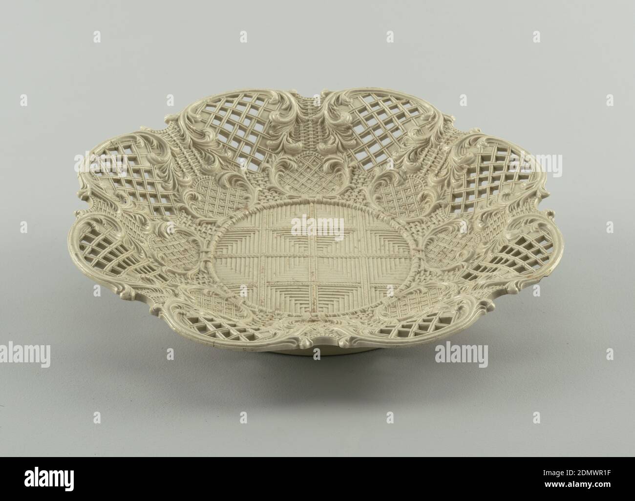 Plate, Molded and pierced salt-glazed stoneware, Round, low basket, molded to resemble weaving. Scrollwork and piercing along sides., Staffordshire, England, ca. 1760, ceramics, Decorative Arts, Plate Stock Photo