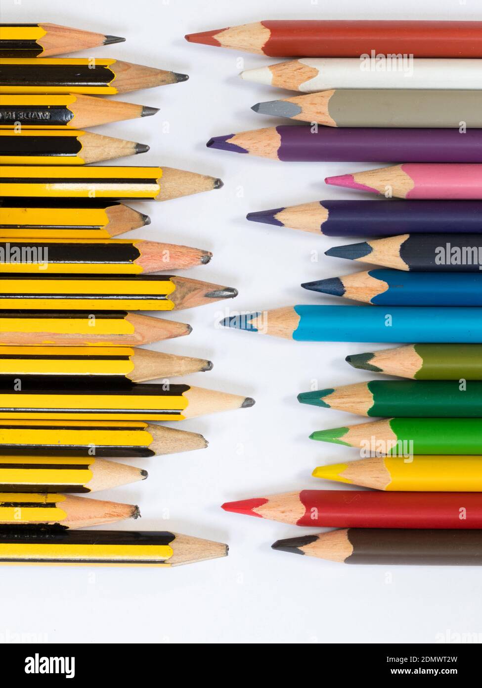 Pencils pointing towards coloured pencils Stock Photo