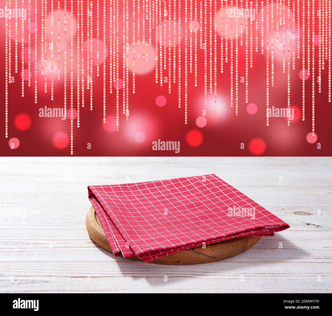Red napkin on wooden table and Christmas background mockup. Stock Photo