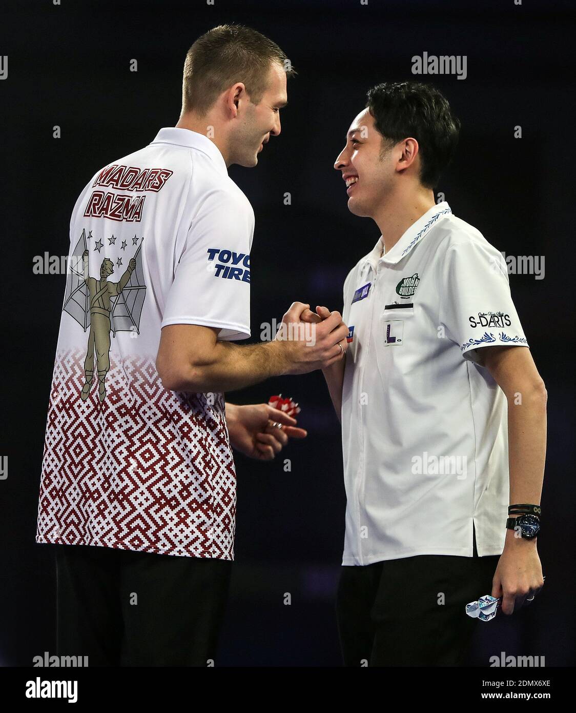 Madars Razma (left) shakes hands with Toru Suzuki after winning his ...