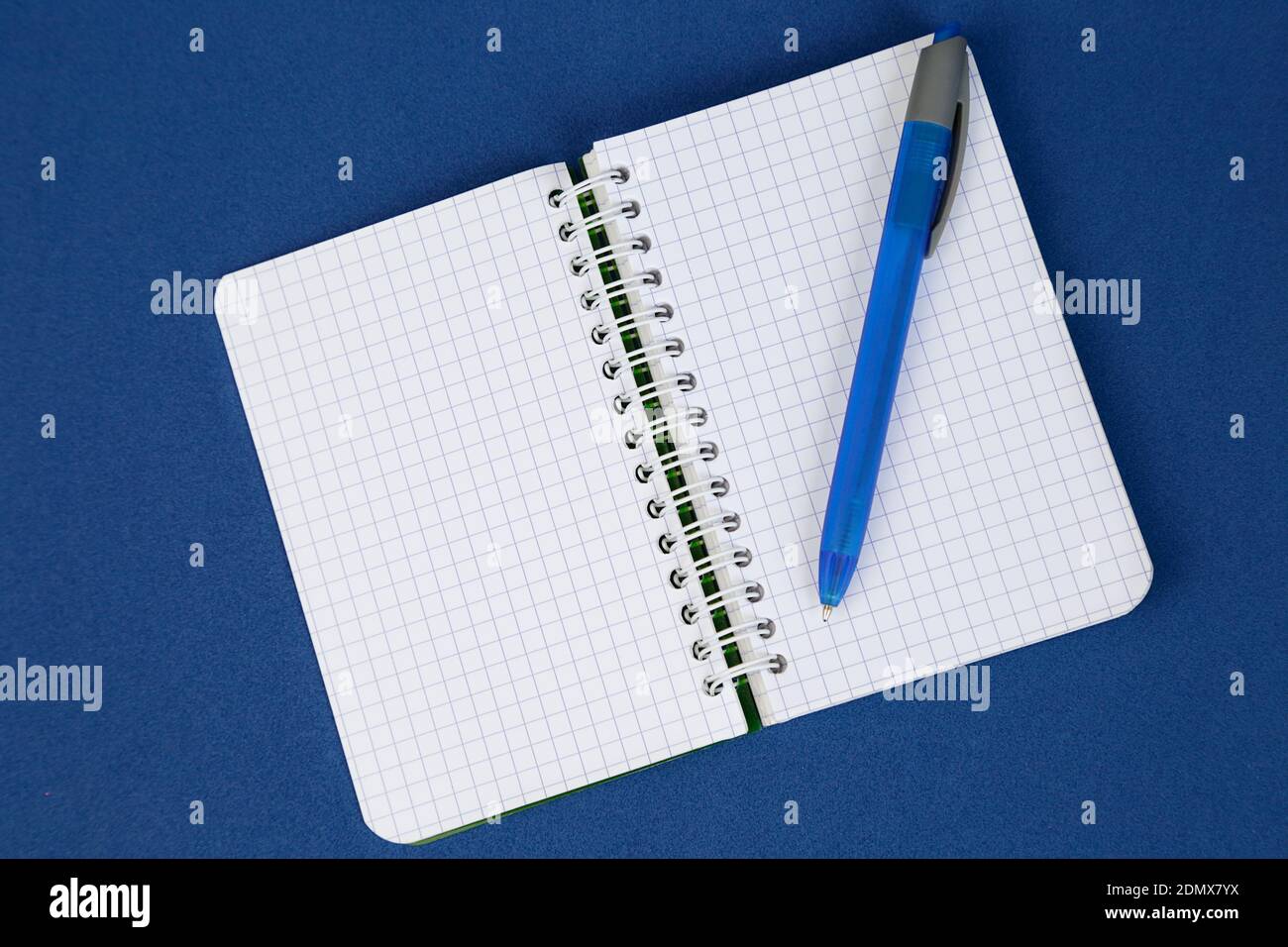 Open notepad and a pen on blue background. Writing concept. Stock Photo