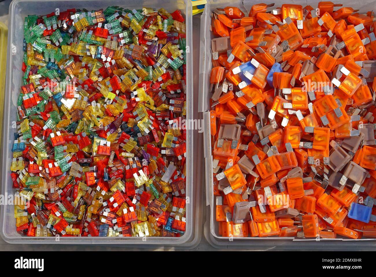 Many color coded fuses for cars in boxes Stock Photo