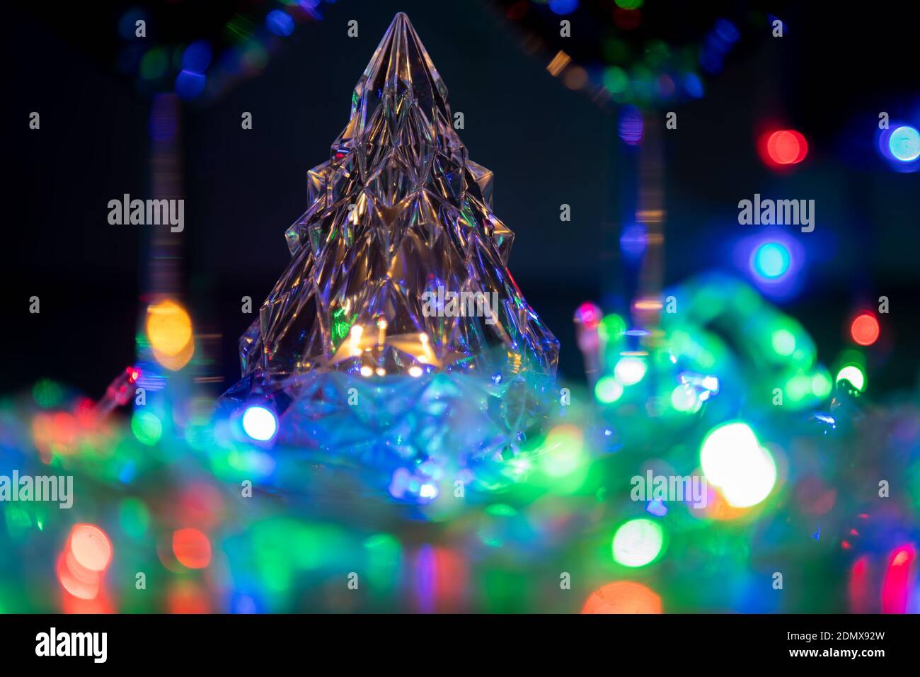glowing crystal tree in multicolored shiny garlands new year and christmas celebration on black background Stock Photo