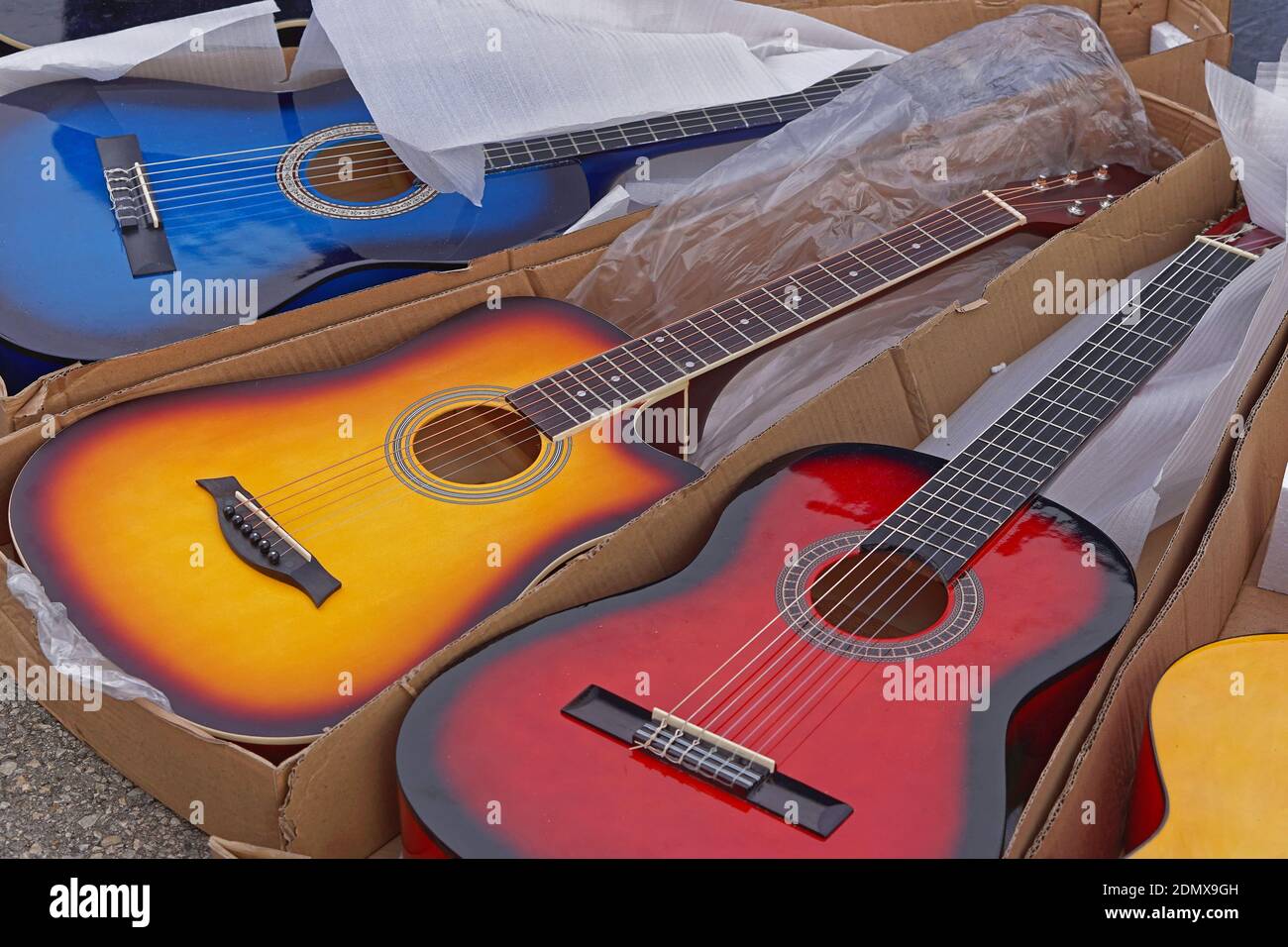 Many new colourful guitars music instruments for sale Stock Photo Alamy