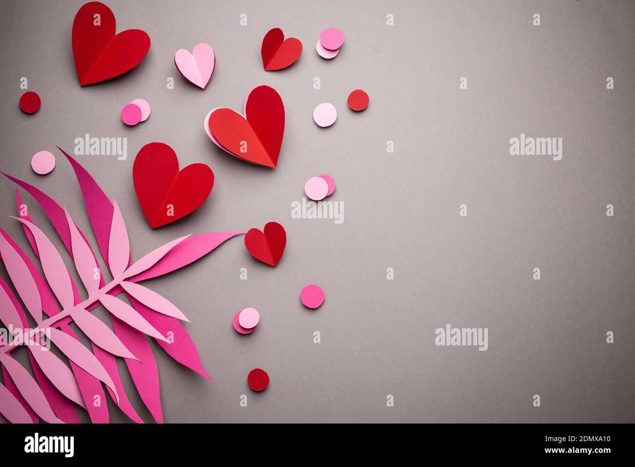 Red hearts cut from paper on pink background, paper craft origami style ...