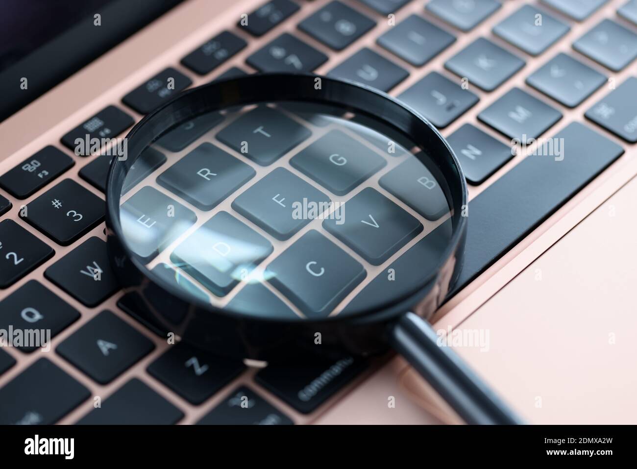 Magnifying glass on keyboard. Information search on Stock