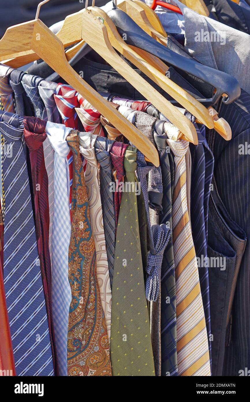 Colourful silk neck ties assortment at coat hangers Stock Photo Alamy