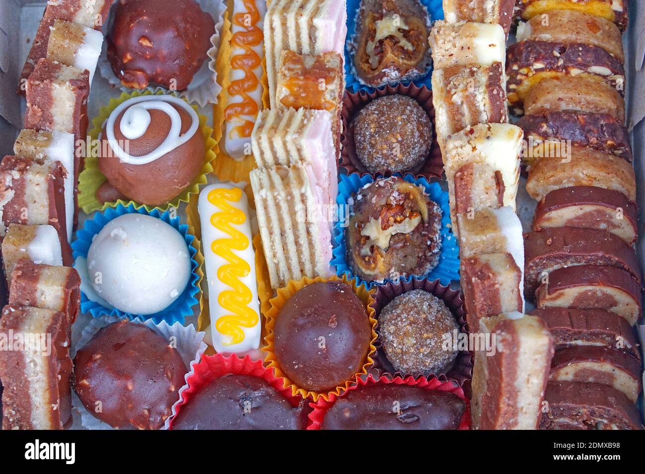 Many tiny cakes dessert selection in party box Stock Photo