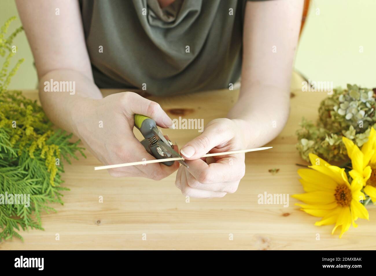 Florist at work: Woman shows how to make floral arrangement with ...