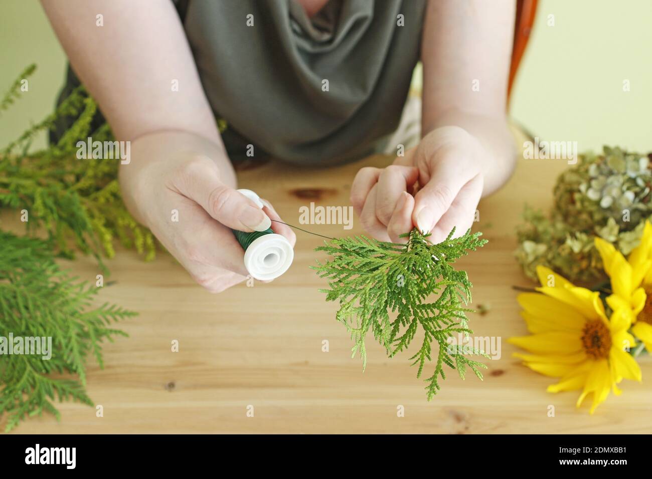 Florist at work: Woman shows how to make floral arrangement with ...