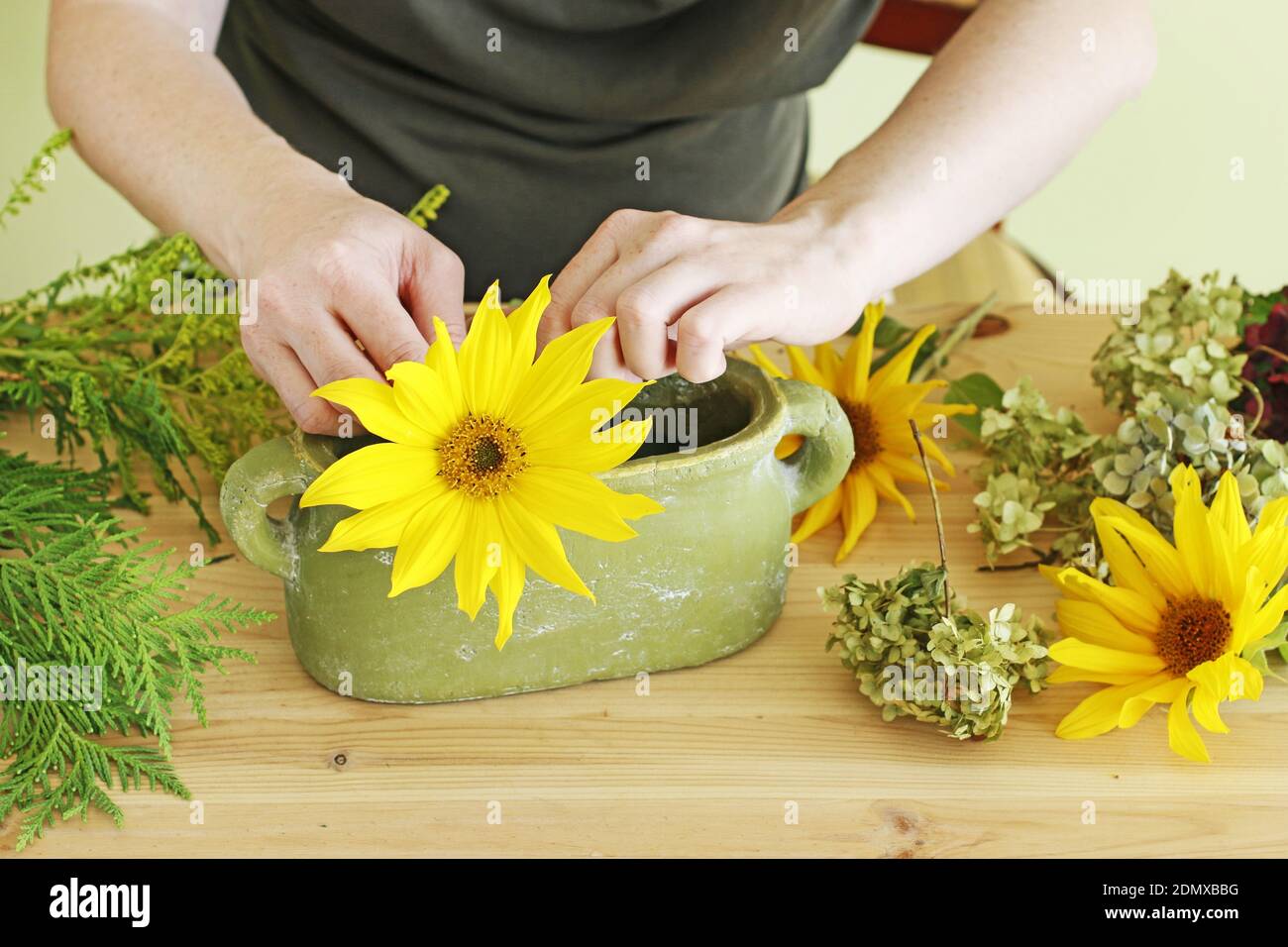 Floral Tutorials Florist at work: Woman shows how to make floral arrangement with ...