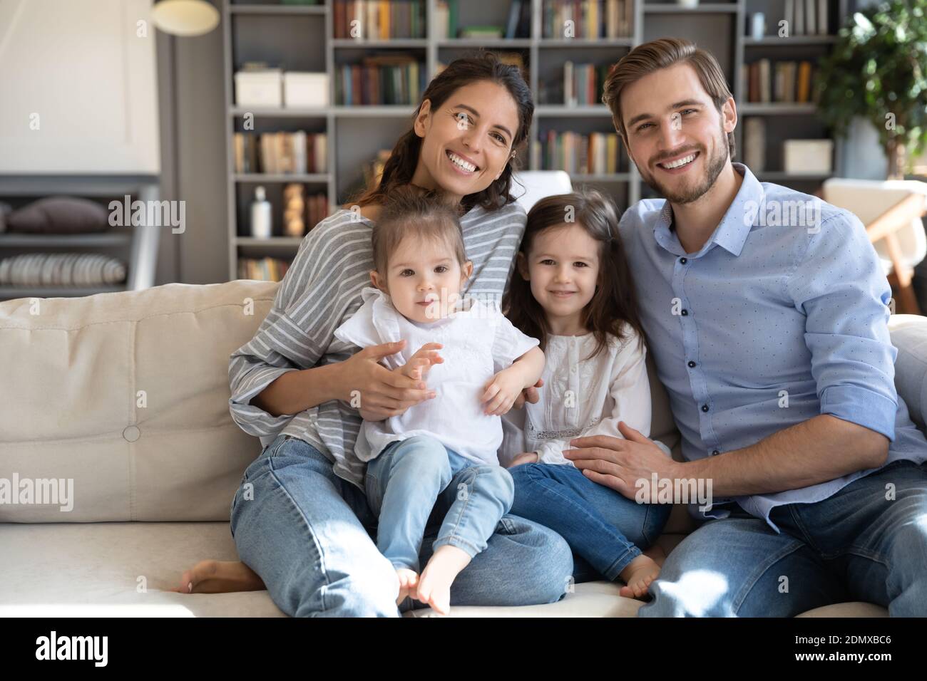 Happy family with little children relax on couch Stock Photo - Alamy