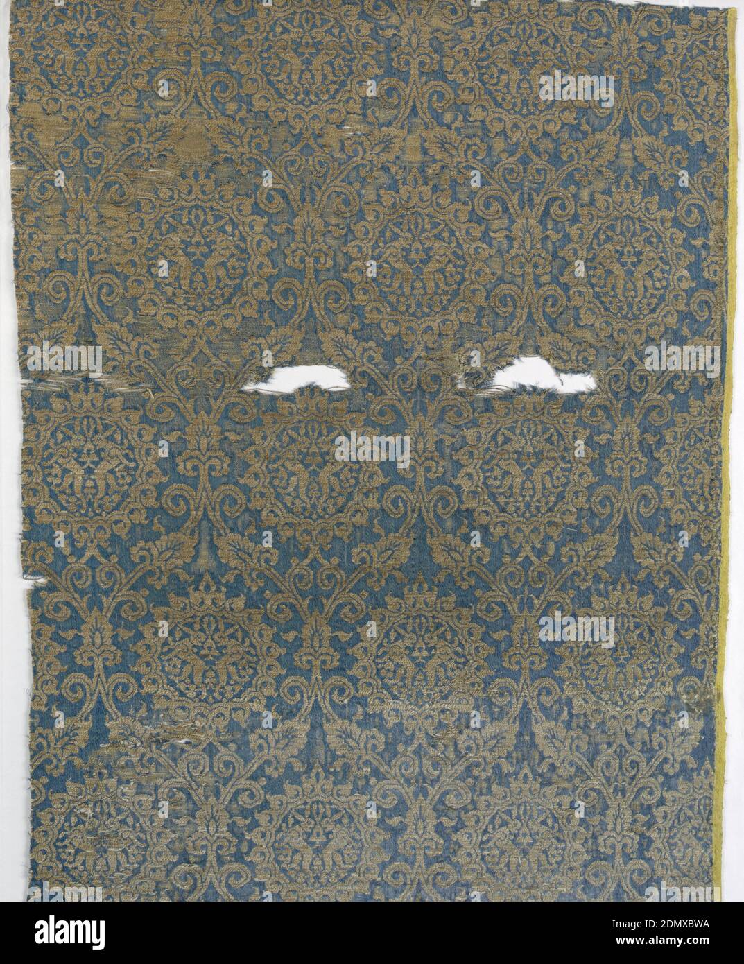 Fragment, Medium: silk, gilded animal membrane around linen core Technique: 4&1 satin and plain weave (lampas), Medallions holding addorsed hares in gold on dark blue., Italy, 14th century, woven textiles, Fragment Stock Photo
