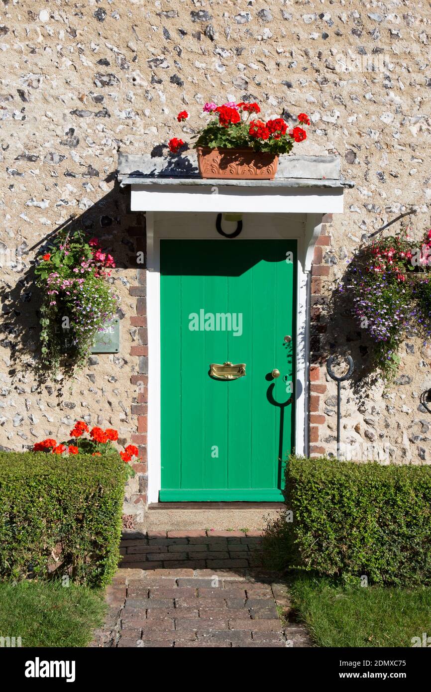 East Dean, East Sussex, England. Bright green door of a typical village cottage. Stock Photo