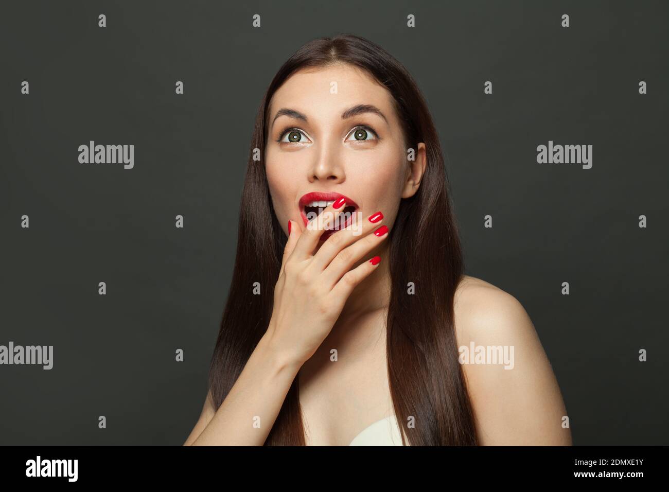 Happy surprised woman on black banner background Stock Photo - Alamy