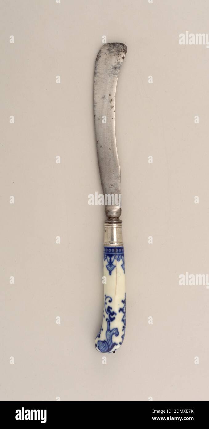 Knife with Blue Pattern, Saint-Cloud Porcelain Manufactory, French, active by 1693 - 1766, porcelain, vitreous enamel, steel, silver, Saber-shaped blade with waisted bolster, plain silver ferrule with horizontal bands. Pistol-shaped white porcelain handle with dark blue floral and scrolled decoration. Button cap at the top of the handle missing., France, ca. 1740, cutlery, Decorative Arts, knife, knife Stock Photo