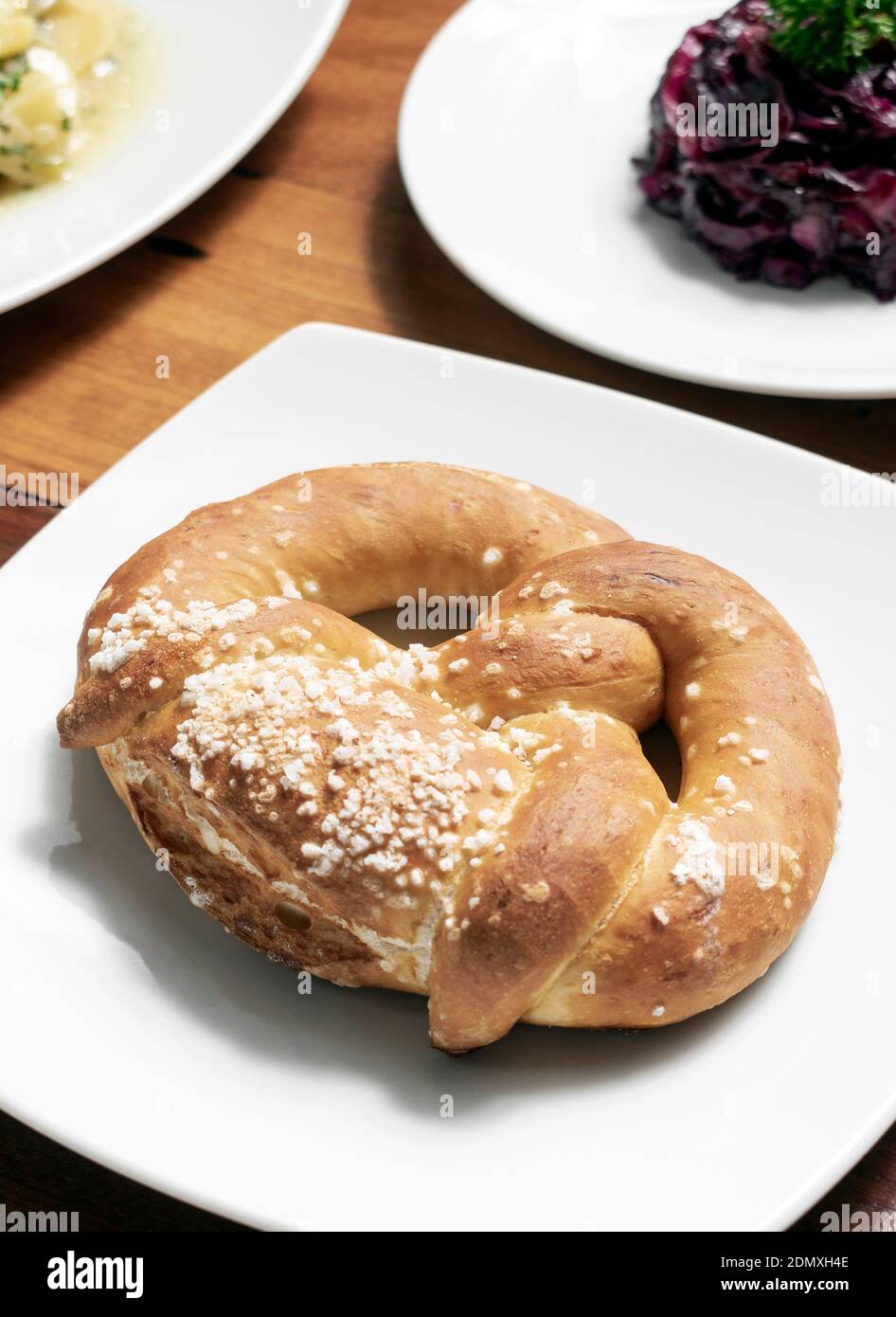 vegan dairy-free organic german traditional pretzel bread on wood table Stock Photo