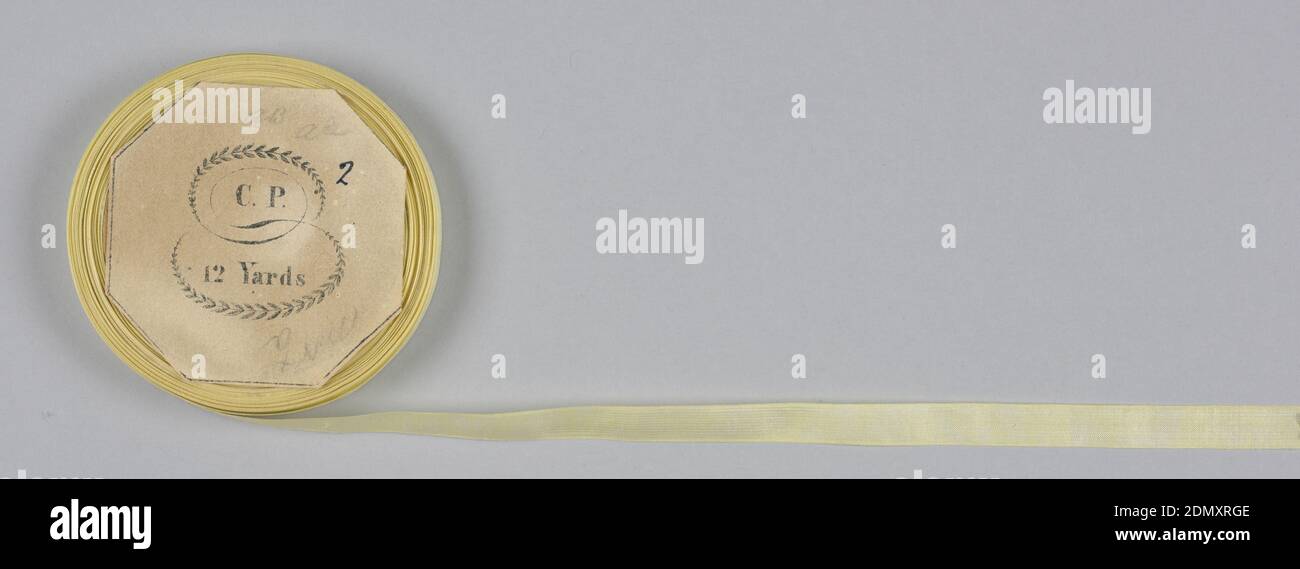 Tape, Medium: silk Technique: plain weave, Yellow tape or seam binding on a flat wooden spool., USA, mid-19th century, woven textiles, Tape Stock Photo