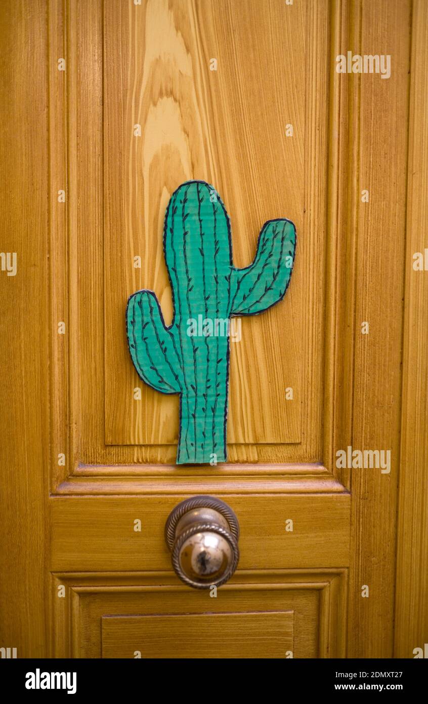 a hand drawn illustration of cactus cut out from cardboard stuck on someones front door of an appartment Stock Photo