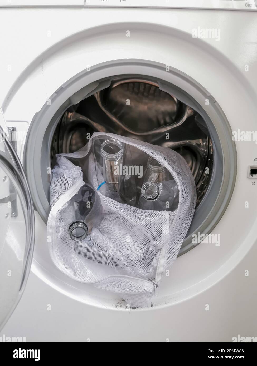Washing machine filled with plastic bottles representing micro plastic