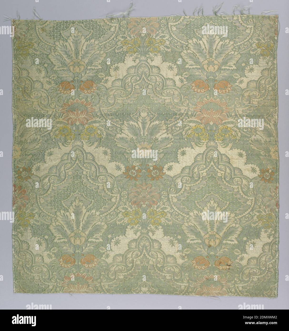 Fragment, Medium: silk Technique: compound weave with supplementary weft patterning (brocade), Silk fragment showing detailed pattern in silvery shades of green and off-white with touches of salmon pink and yellow. Design has a symmetrical motif in two variants with a vertical bunch of flowers surmounted by fanning leaves surmounted by decorated pear-shaped cartouche with diaper filling, in a close-set medium sale diagonal repeat giving allover effect., France, early 18th century, woven textiles, Fragment Stock Photo