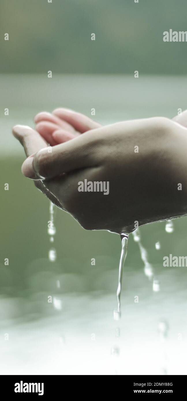 Closeup Of Water Dripping From Hands Cupped Stock Photo Alamy