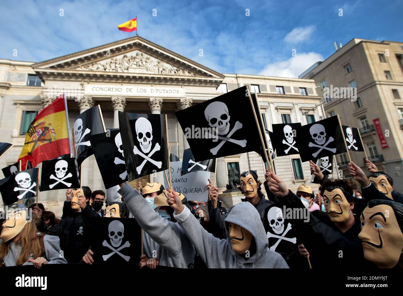 Madrid, Spain; 17/12/2020.- Today it is expected that the Spanish Congress of Deputies will approve organic law regulating euthanasia. Dozens of people are protesting before Congress against the euthanasia law with the slogan 'Government of death' rally, called by the 'Vividores' (Livers) campaign, promoted by the the Catholic Lawyers Association and far-right groups such as the political party Vox whose leader Santiago Abascal left Parliament to support them.The protesters have carried Spanish masks, banners and flags with the pirate symbol of the skull and two crossed femurs. They were shout Stock Photo