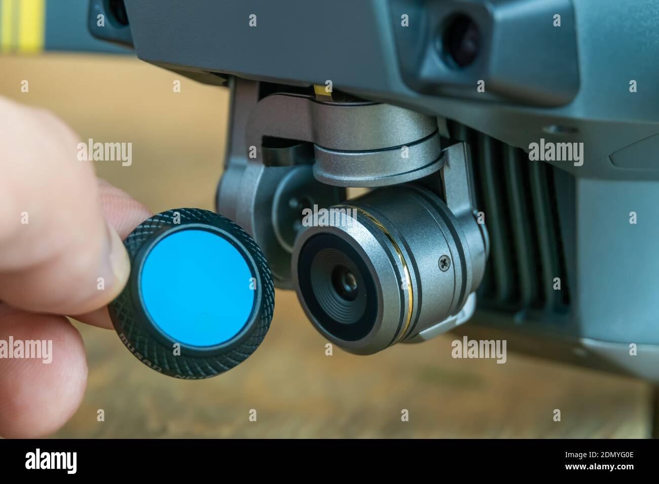Man's hand puts on a closeup drone camera filter Stock Photo Alamy