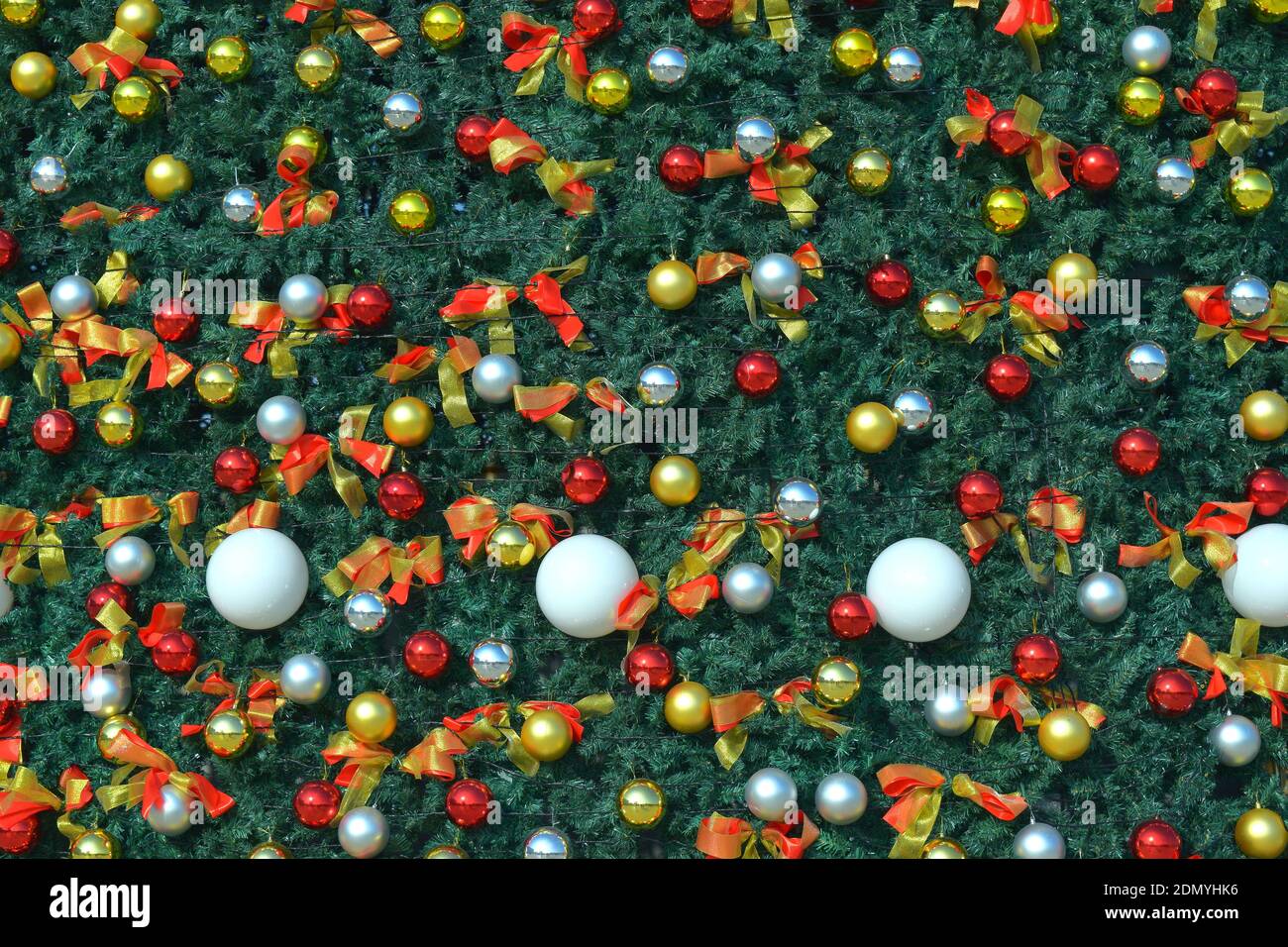 festive background with colored balls on christmas tree Stock Photo - Alamy