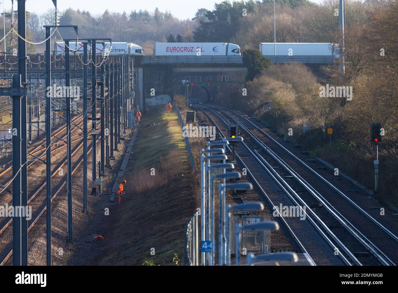 Railway workers strimming the rail verge, westerhanger, kent, uk Stock Photo