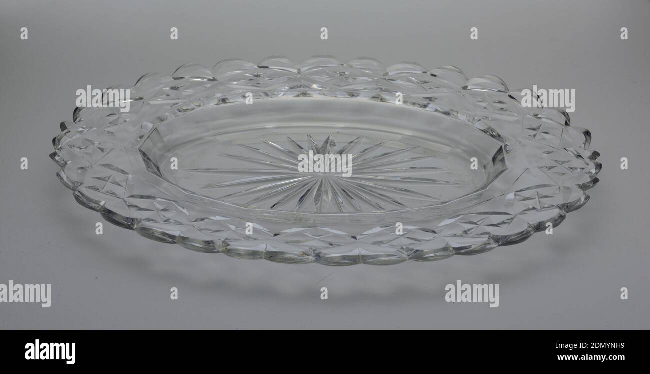 Dish, Glass, Oval dish with wide rim scalloped at the edge, star cut at center, cavetto with facets, the rim cut with flat diamond pattern, glass clear and heavy., Ireland, ca. 1790, glasswares, Decorative Arts, Dish Stock Photo