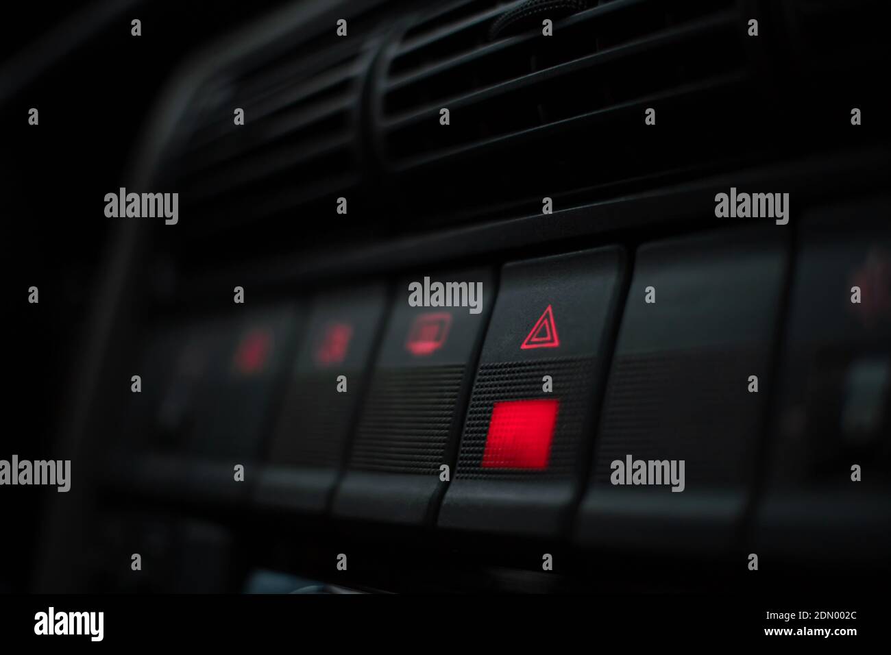 Emergency button highlighted in red on the instrument panel close up Stock Photo