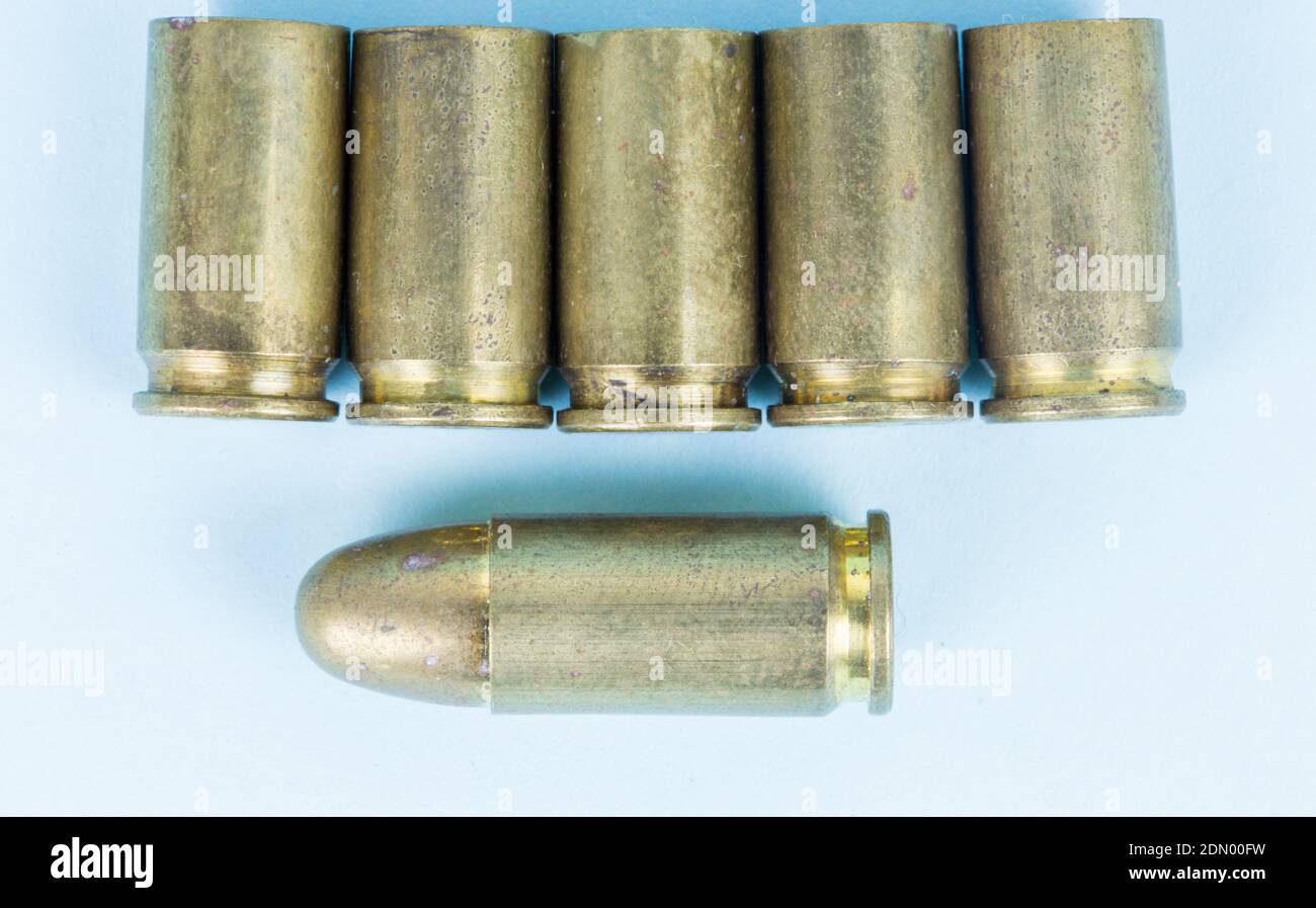 fired bullets, bullet casings photographed up close on a blue background,  pistol bullet Stock Photo - Alamy
