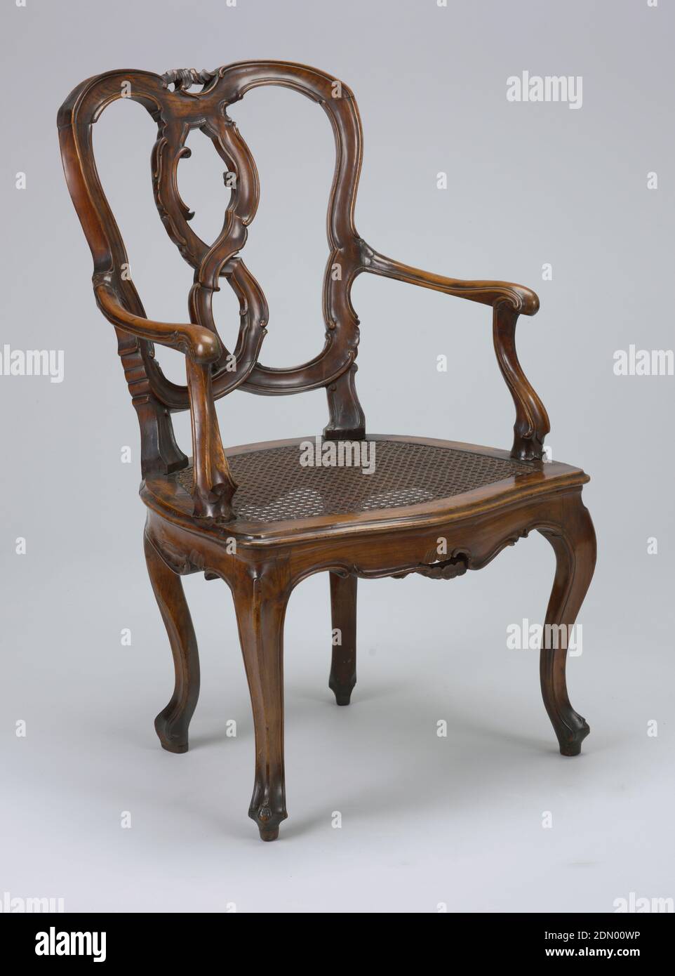 Armchair, Carved fruitwood, The open back and splat are formed by two intertwined curvate members moulded with scrolls. Curved arms and arm stumps. Cabriole front and rear legs. seat caned., Venice, Italy, ca. 1750, furniture, Decorative Arts, Armchair Stock Photo