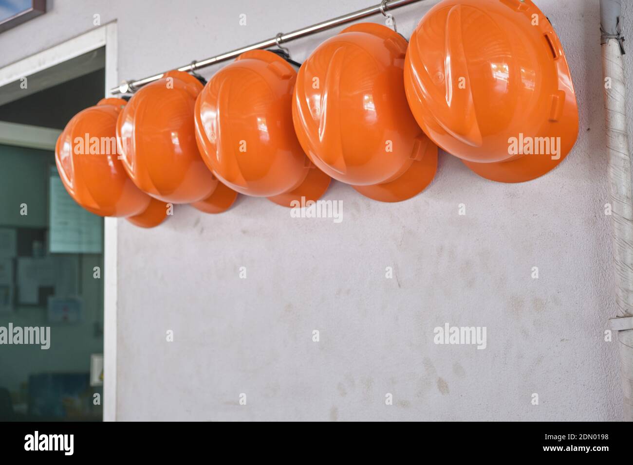 Orange safety hats hi-res stock photography and images - Alamy
