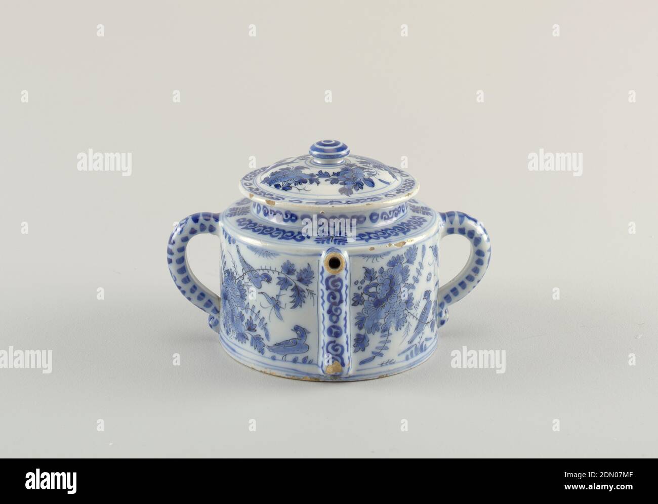 Posset Pot, De Paauw (Peacock) Factory, Dutch, active 1651 - 1774, Tin-glazed earthenware, Cylindrical body with straight sides; 2 loop handles opposite sides; spout rises along side body, projects horizontally from squared shoulder; domed lid with wide lip and flattened knop finial; painted in underglaze blue on white with chinoiserie birds, flowers, scroll bands., Delft, Netherlands, 1705–40, ceramics, Decorative Arts, posset pot, posset pot Stock Photo