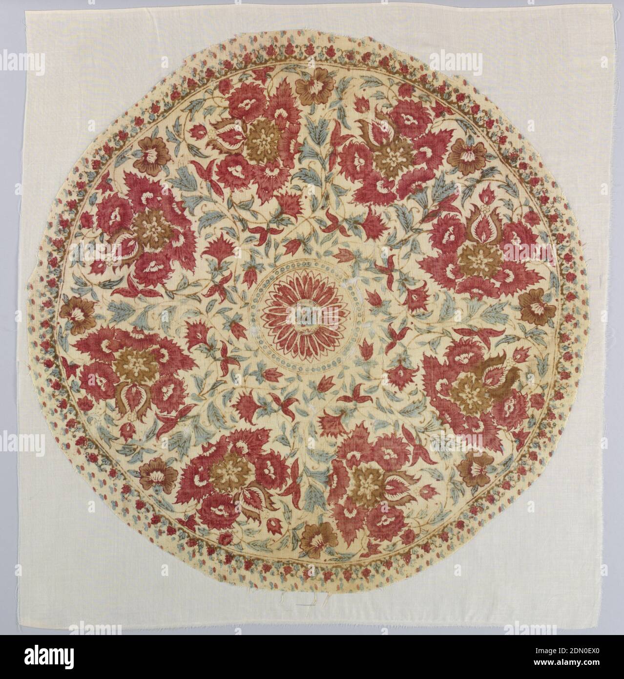 Fragment, Medium: cotton Technique: block printed on plain weave, Round fragment of cream-colored cotton block printed in reds, violet, and green. A floral pattern is arranged to fill a circle of flower heads. Center round medallion has a stylized flower head forming a rosette., India, 19th century, printed, dyed & painted textiles, Fragment Stock Photo
